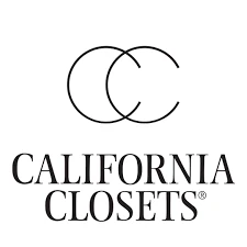 Custom walk-in closet by California Closets with white shelving, built-in drawers, and integrated lighting